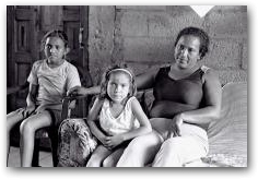 Pamela Ramirez, sitting with her family at home in San Carlos  -> Click to enlarge