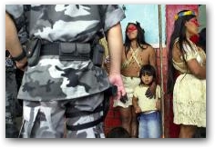 Huaorani women stand near military police before the start of march on the opening day of the trial against ChevronTexaco in Lago Agrio  -> Click to enlarge